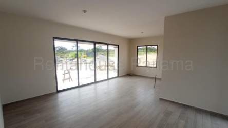 Bright empty living room with large windows overlooking greenery in new Boquete property