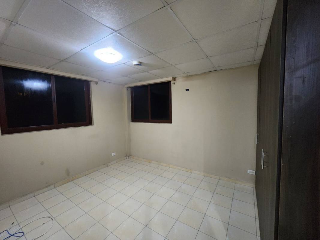 Empty bedroom with drop ceiling, tile floor, and wardrobe in PH Danli Rio Abajo Panama