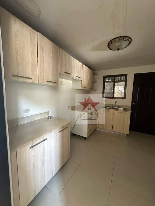 Kitchen with cabinetry, neutral countertop, window PH Green Village San Miguelito Panama