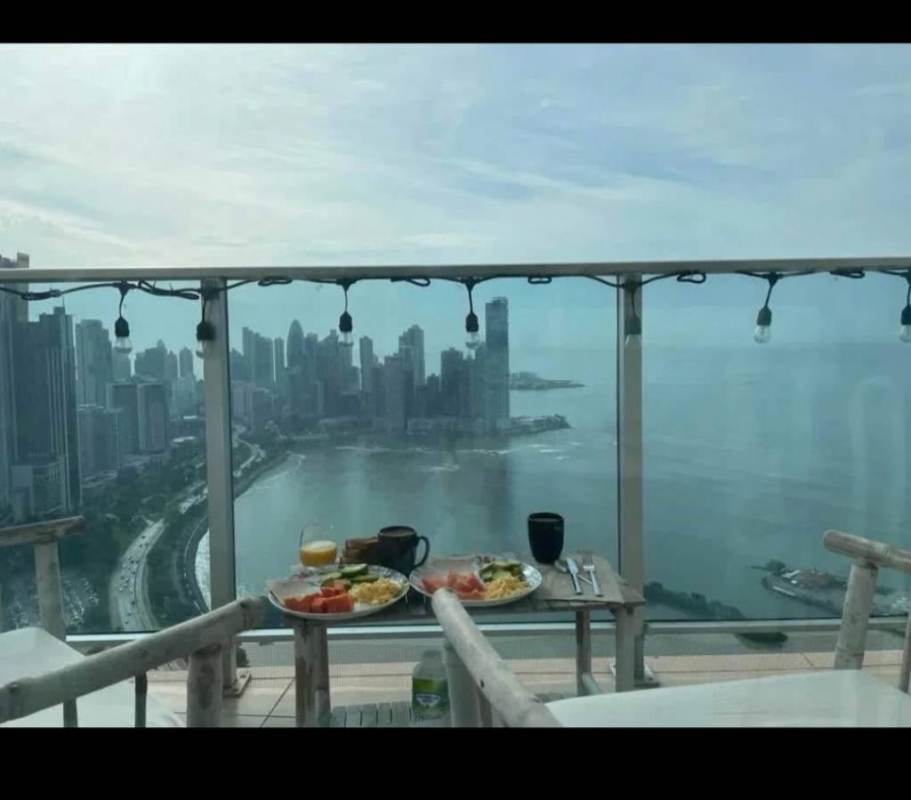 Balcony with furniture overlooking Pacific Ocean and city skyline PH White Tower Avenida Balboa