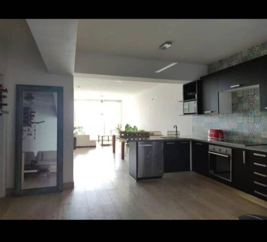Modern kitchen and dining area with natural light and ocean view in PH White Tower Panama City