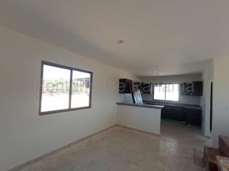 Modern kitchen with dark cabinets, granite style counters and window in Alto Boquete house