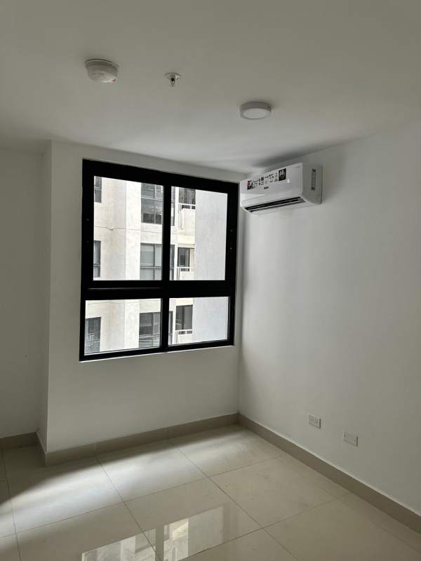 Minimalist bedroom with large window and AC at PH Vía España Tower Panama City