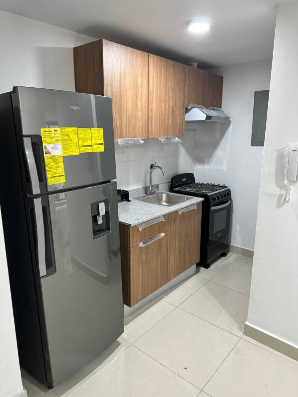 Modern kitchen with granite, fridge, stove and wooden cabinets Panama