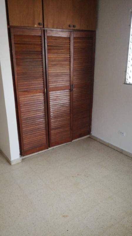 Bedroom with built-in wooden wardrobes in affordable Panama house