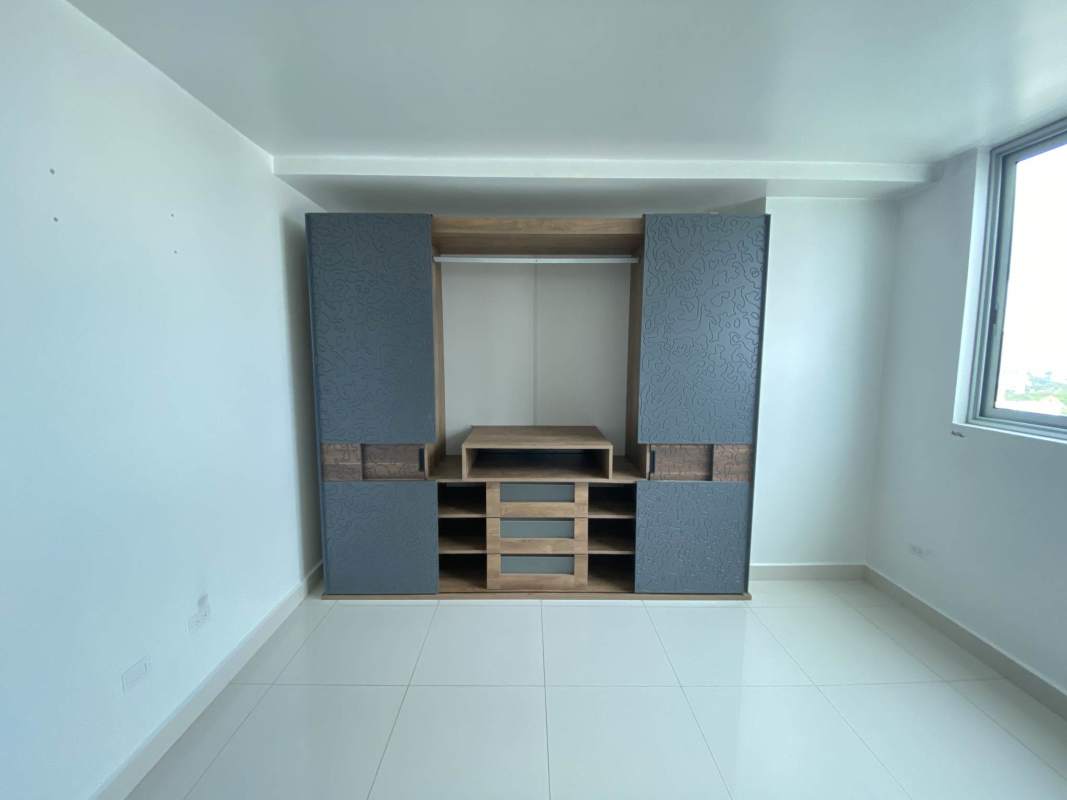 Master bedroom with built-in closet and ocean skyline view at PH Midpark Carrasquilla