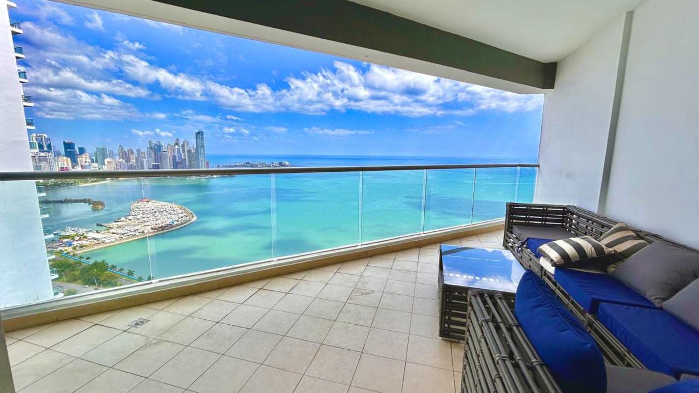 Modern balcony with panoramic ocean and skyline view, outdoor sofa at PH BICSA Panama City