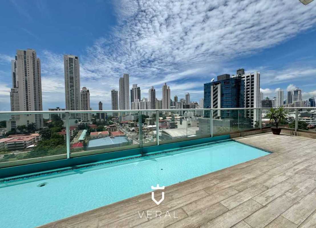 Spectacular infinity rooftop pool with glass railing and panoramic ocean skyline view at PH Quartier del Mar Panama City