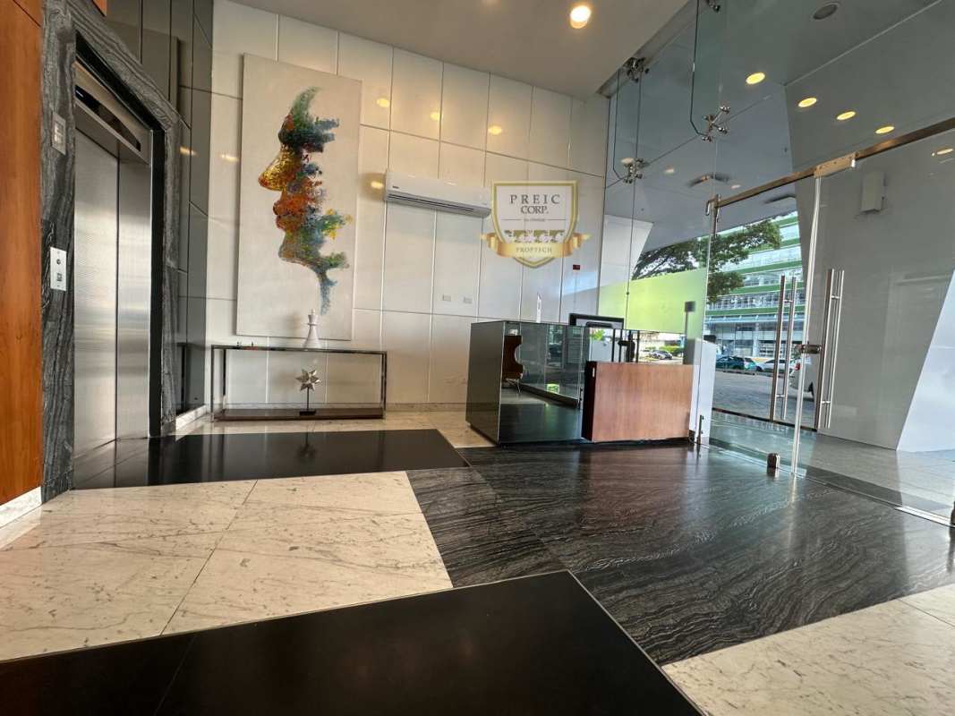Modern lobby entrance with marble floors, elevators and artwork in PH Metropolitan Park Panama City
