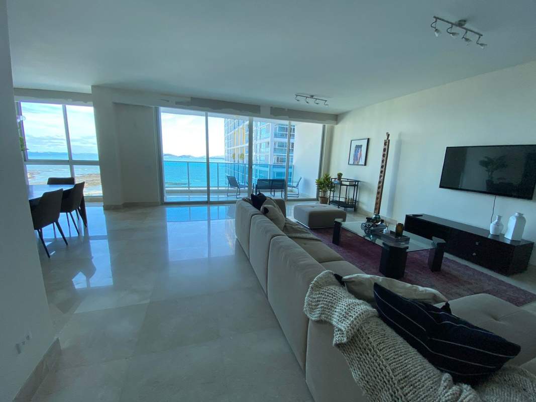 Large bedroom with expansive window showing Panama City skyline at night in PH Marabierto