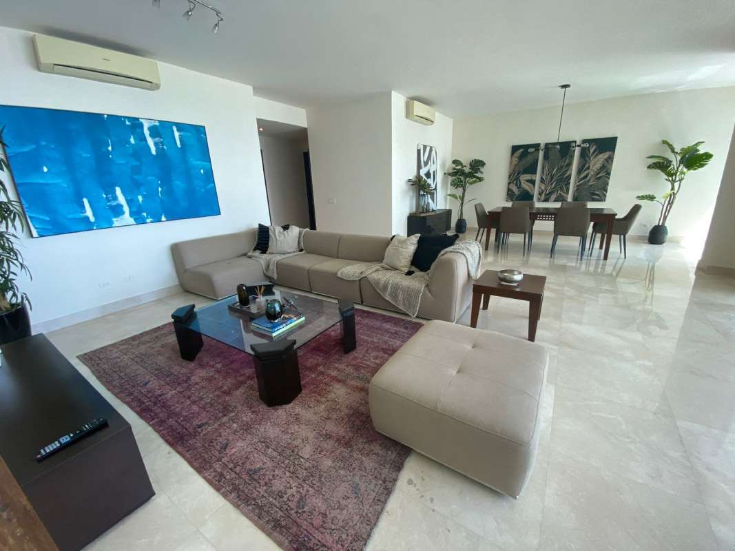 Open concept living dining room with balcony access and views of Pacific Ocean at PH Marabierto Panama City