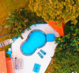 Outdoor pool with waterfall feature covered patio garden in Altos de María Panama