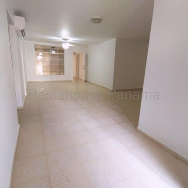 Spacious living room with marble flooring and large windows in Costa del Este house Panama