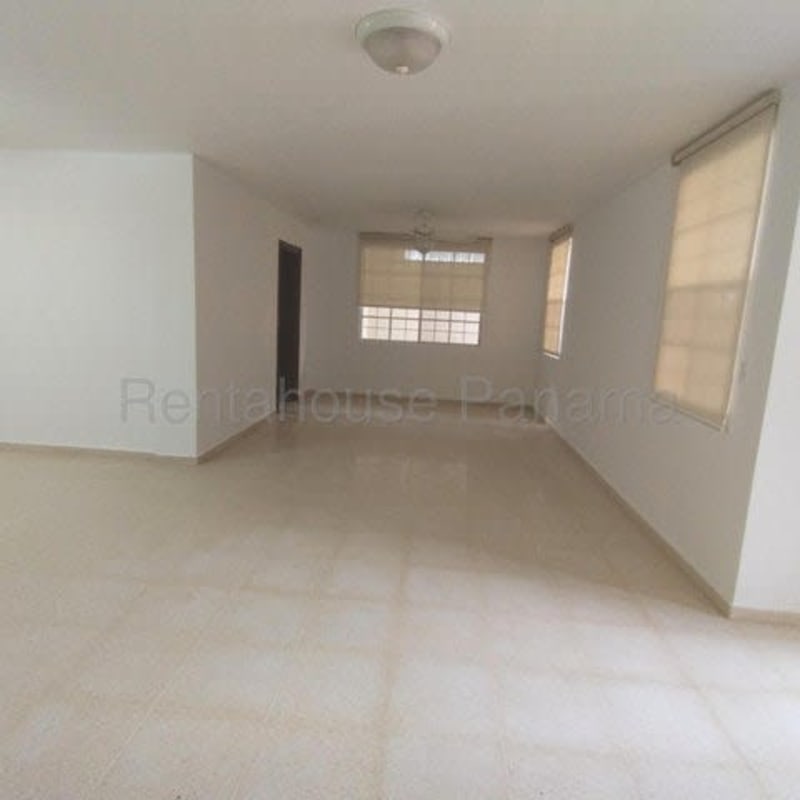 Functional kitchen with dark cabinets, tile backsplash, and ample storage in Costa del Este house