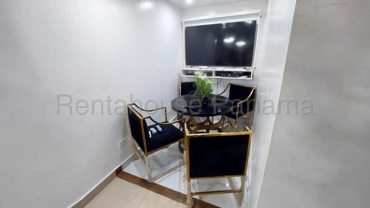 Dining nook with round table recessed lights and TV Panama house rental Condado del Rey