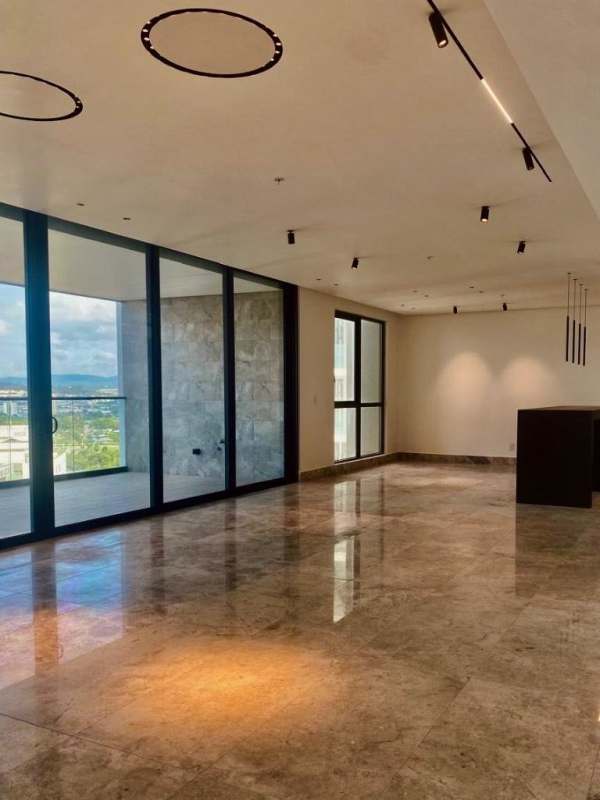 Modern spacious living and dining room with marble floors and balcony at Empire Residences Panama