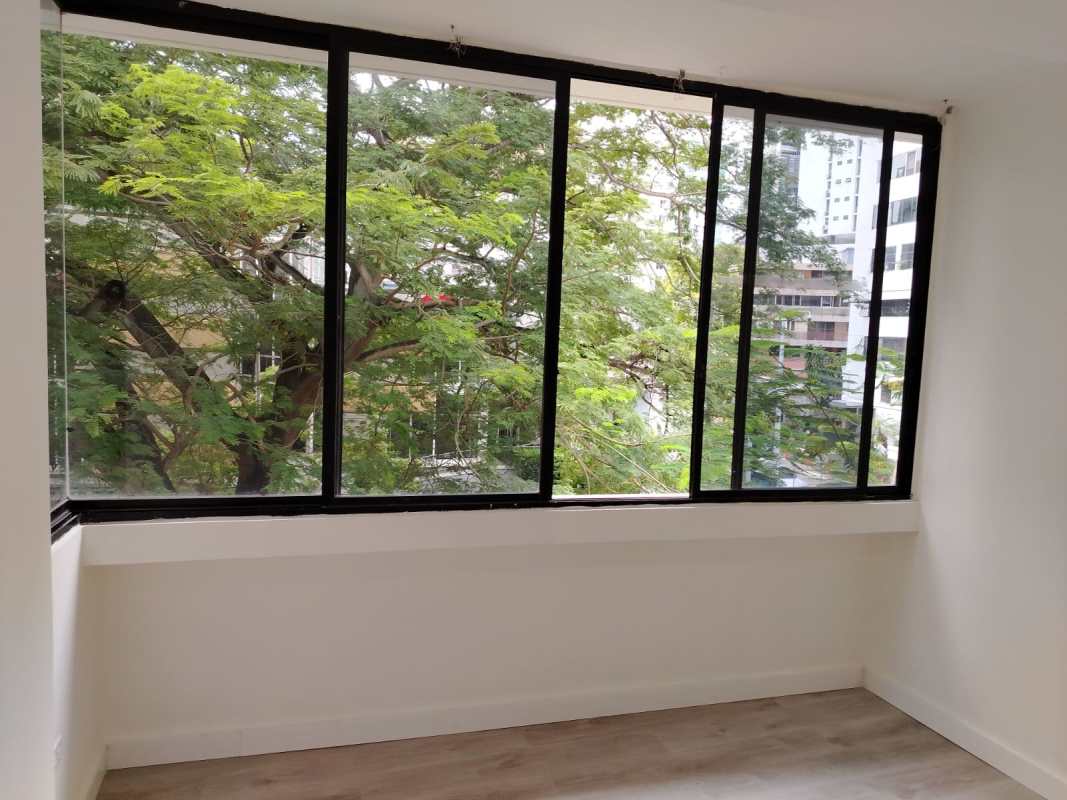 Bright living room with large floor-to-ceiling windows city view PH Aurora El Cangrejo Panama