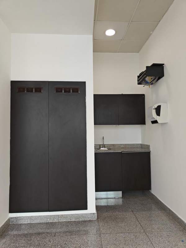 Compact kitchenette with granite countertop cabinets at PH Habitats Plaza Bella Vista Panama