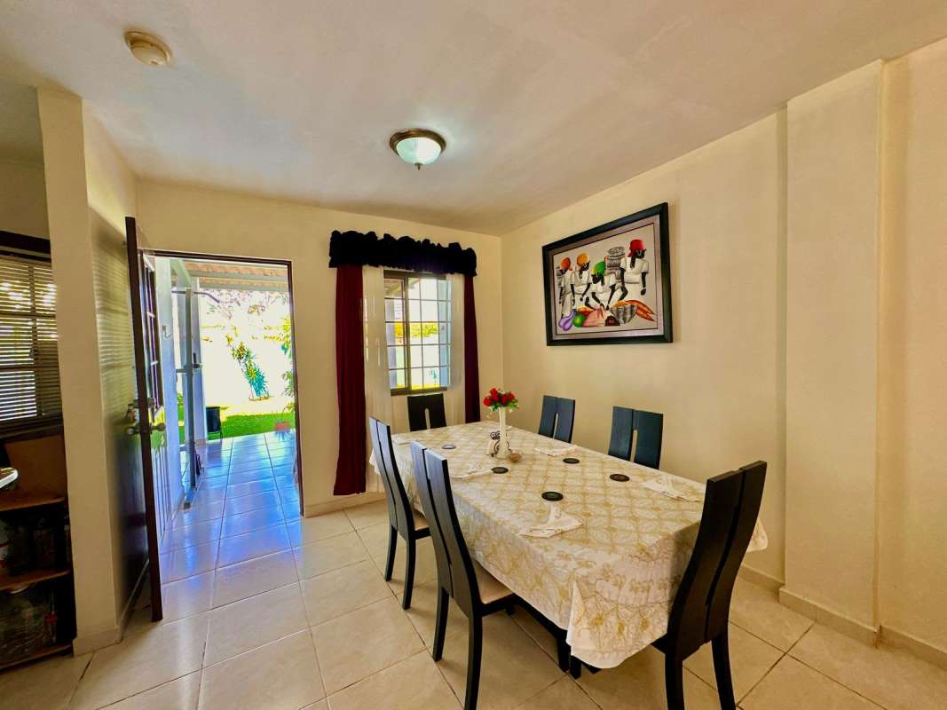 Spacious dining area with large windows and patio door Panama City house