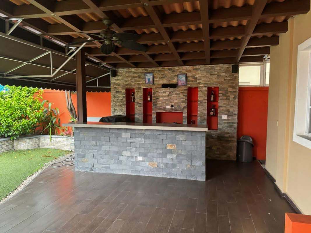 Outdoor bar area with stone accents and garden Villas Castel Novo Juan Díaz Panama