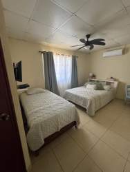 Covered patio terrace with hammock, outdoor dining, garden and fence in Mirador del Bosque Las Tablas Panama