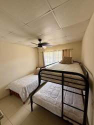 Cozy illuminated terrace patio with hammock, string lights, and seating at Mirador del Bosque Las Tablas