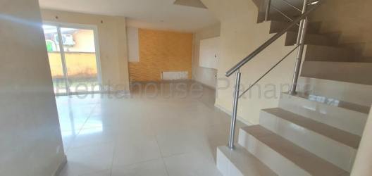 Spacious modern kitchen with dark cabinets, tile backsplash and large window in Arraiján duplex