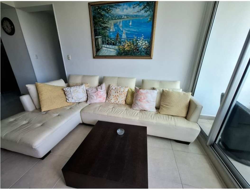 Spacious living room with natural light, large sectional sofa, and access to balcony in PH Clayton Park I