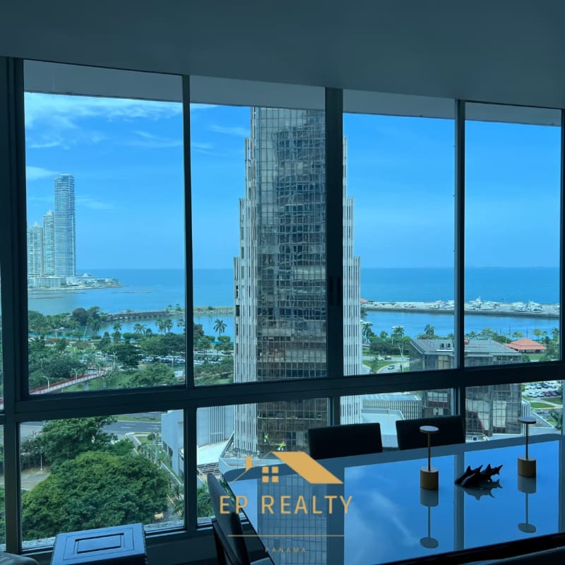 Dining area with floor-to-ceiling windows offering panoramic ocean and city skyscraper views Bella Vista Panama