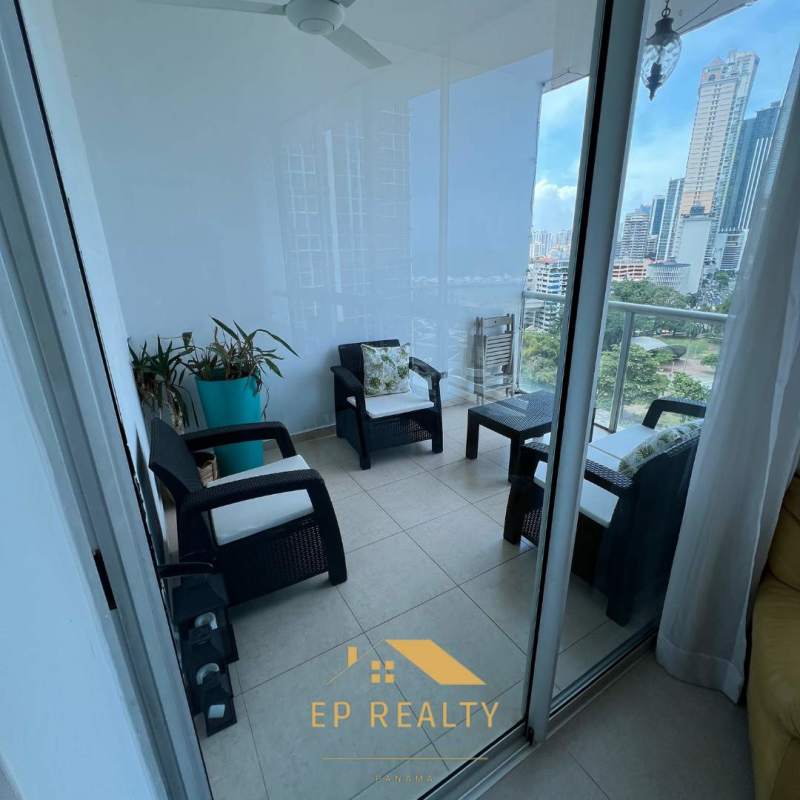 Dining with floor-to-ceiling windows showcasing skyline and Pacific ocean PH Vista Marina