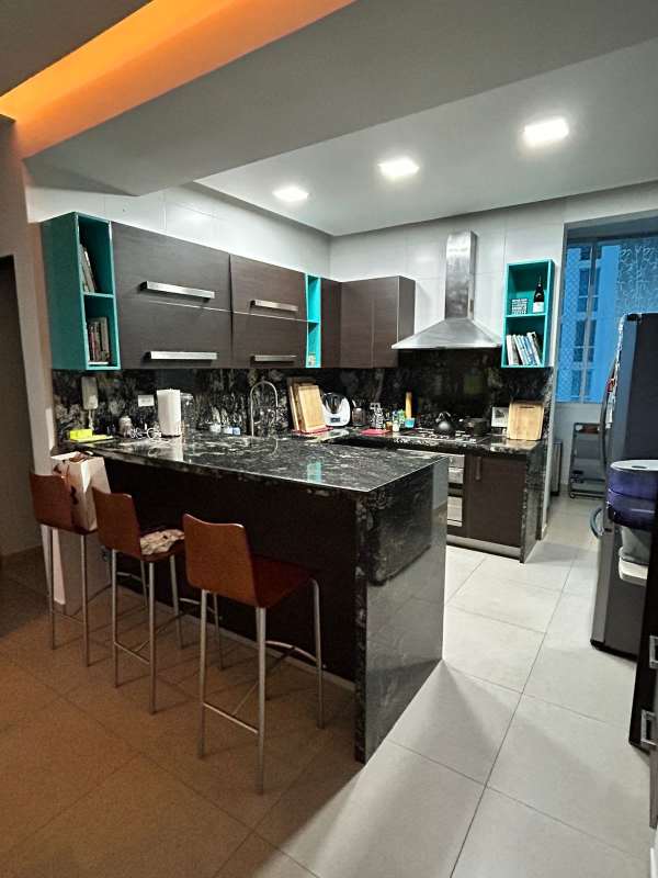 Enclosed kitchen with granite countertops, breakfast bar, modern cabinetry PH Vista Marina Bella Vista Panama