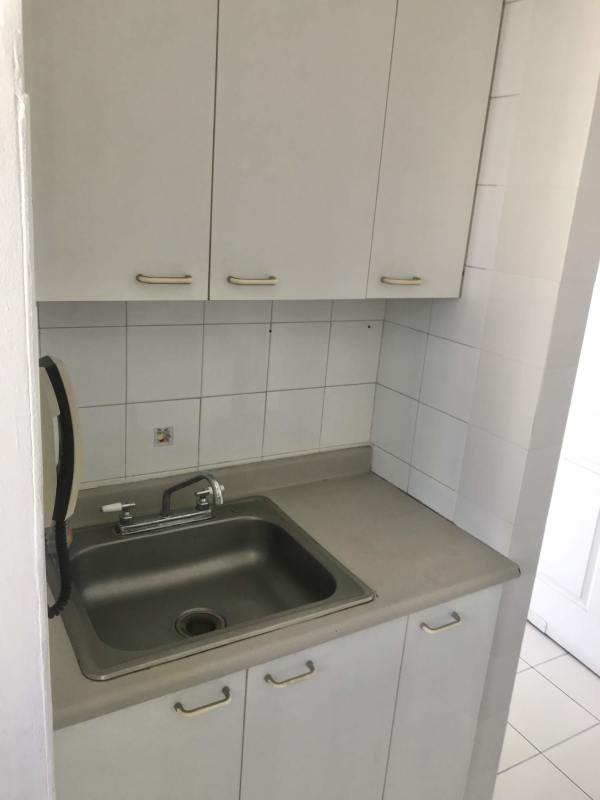 White minimalist kitchen cabinets sink tile backsplash PH Royal Center Marbella