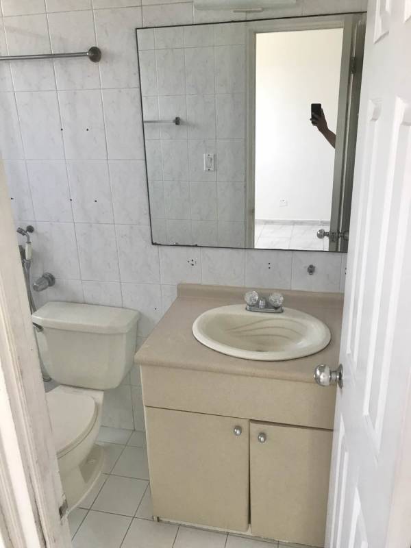 Unfurnished living room with large corner windows and skyline views PH Royal Center Marbella Panama