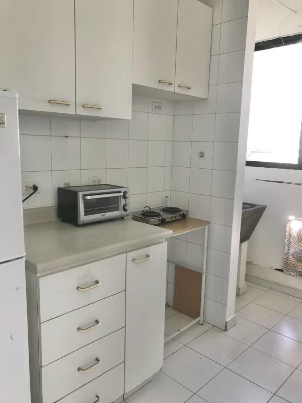 Minimalist kitchen with white cabinetry compact design apartment PH Royal Center Panama City
