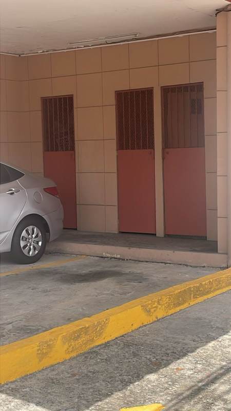 Multi-story residential building with balconies, gated entrance in PH Lefevre Residence