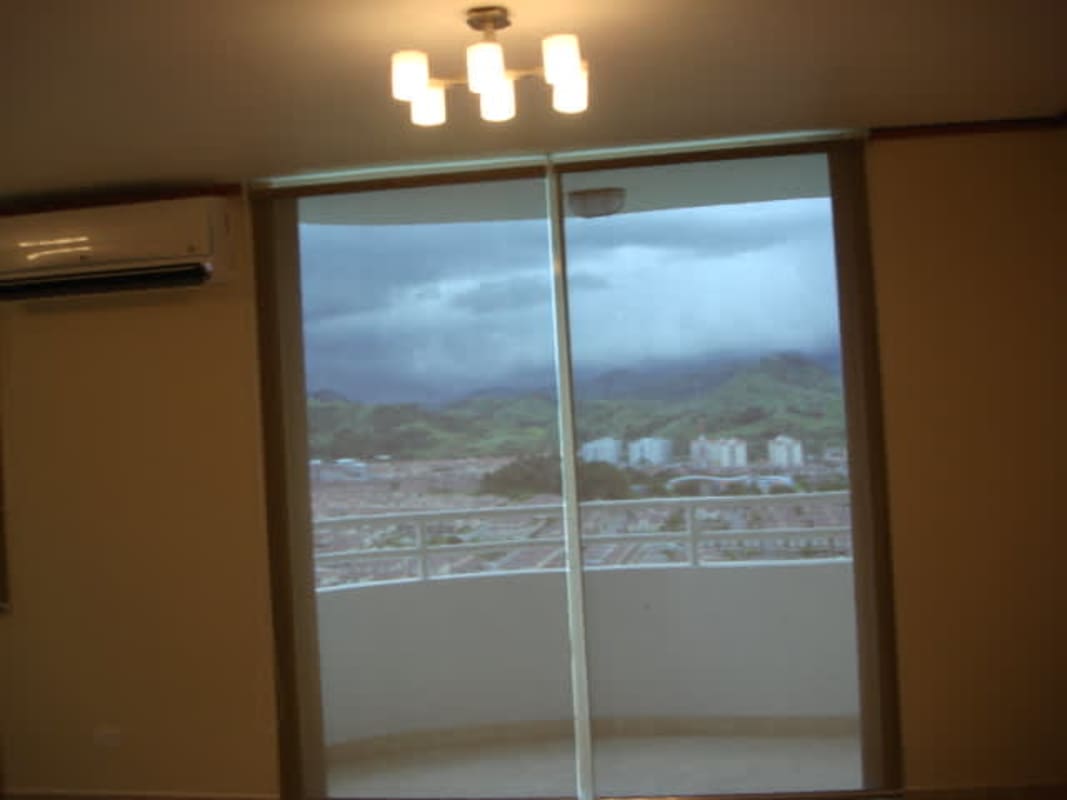 Bedroom with split AC, window, and tile flooring at Green Park Towers Altos del Chase Panama City