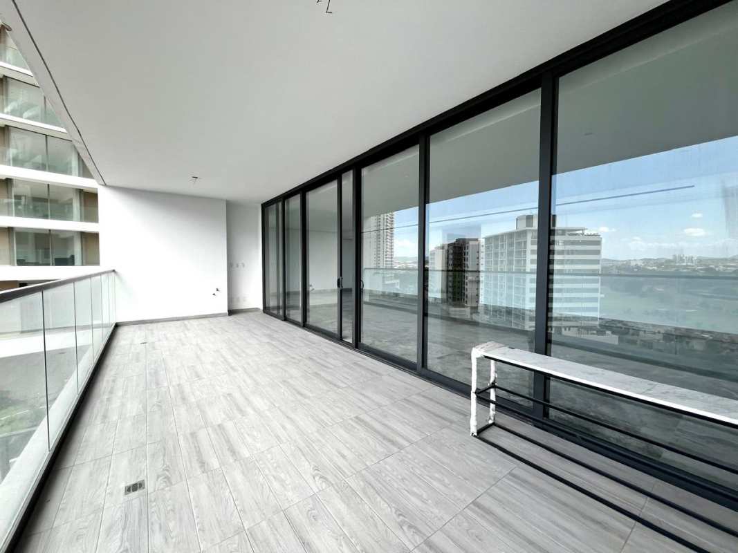 Contemporary kitchen with marble floors and a central island in luxury Santa María Panama apartment