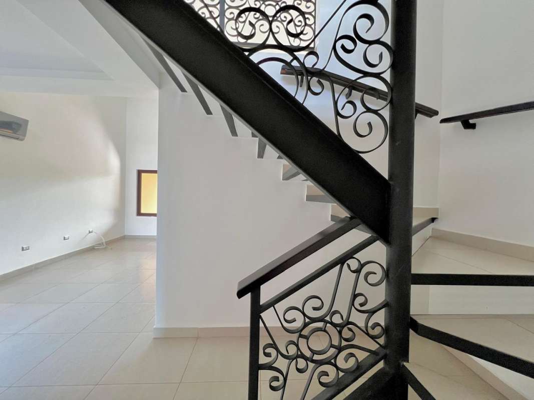 Private covered backyard terrace opening to landscaped garden Costa Sur Panama