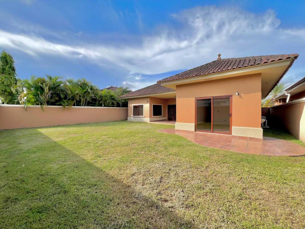 Spacious fenced backyard with covered patio and garden Costa Sur residences