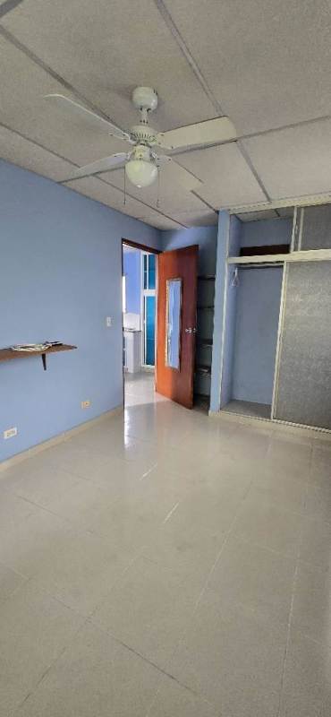 Upper and lower cabinets blue and white tile floor kitchenette in studio El Carmen Panama City