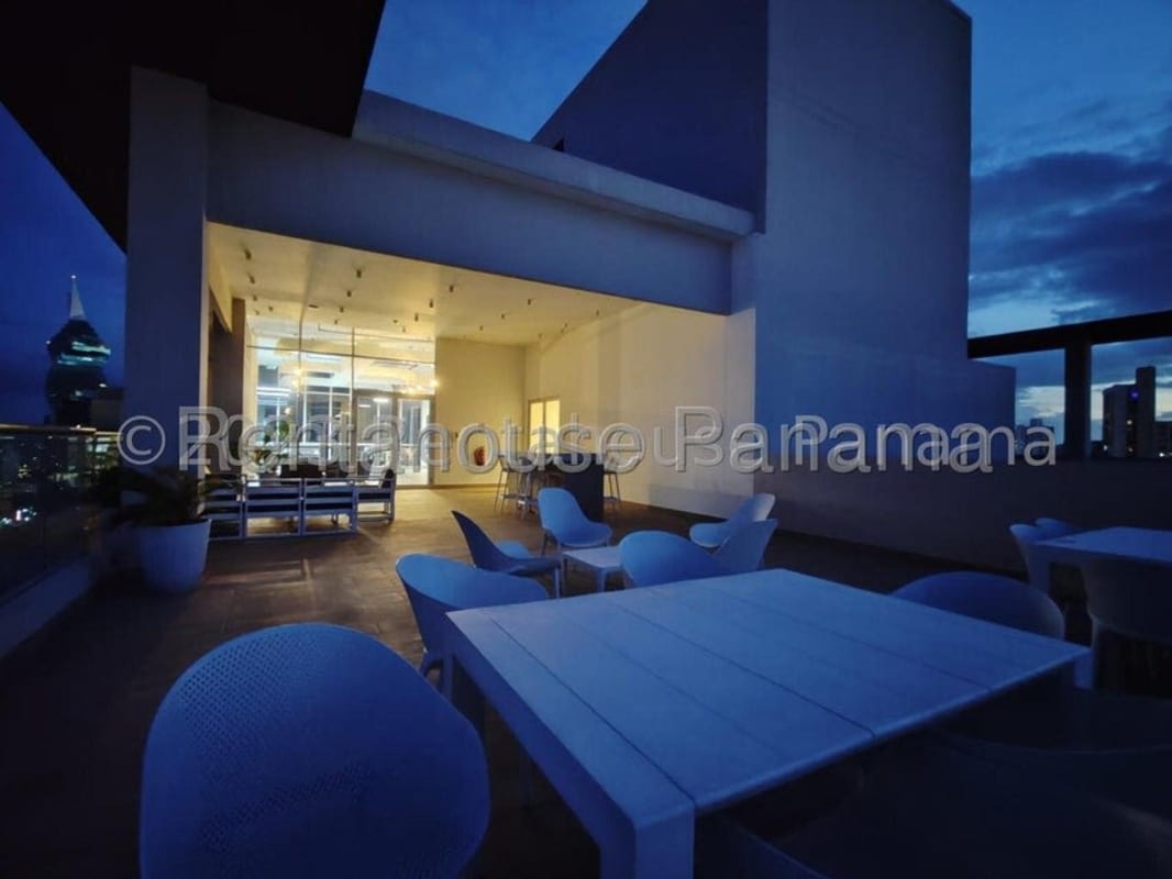 Rooftop outdoor lounge terrace with seating overlooking Panama City skyline