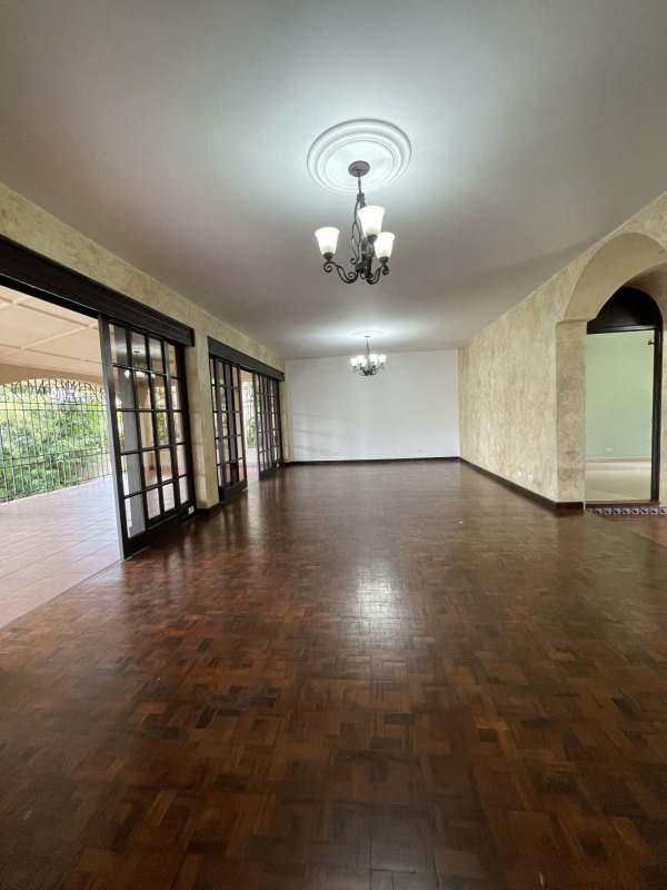 Luxury traditional living room with parquet floors, glass doors to terrace, chandeliers in Panama City home