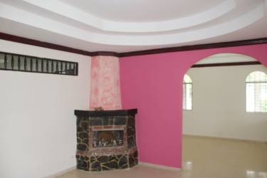 Covered porch with arches and metal bars, front entrance of house in Natá Coclé Panama