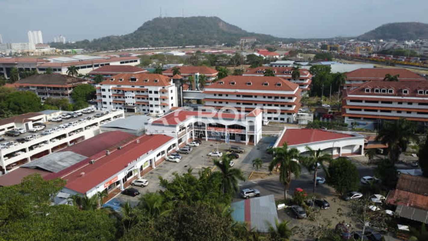 Elevated view of Albrook View Plaza retail buildings with parking lot and landscaped greenery