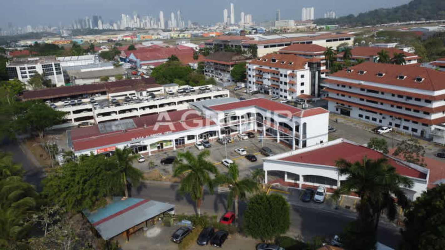 Aerial panoramic of Albrook View Plaza shopping plaza showing rooftops, parking and surroundings