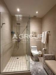 Master bedroom with large window, neutral decor, balcony with ocean view at Playa Escondida Maria Chiquita Panama