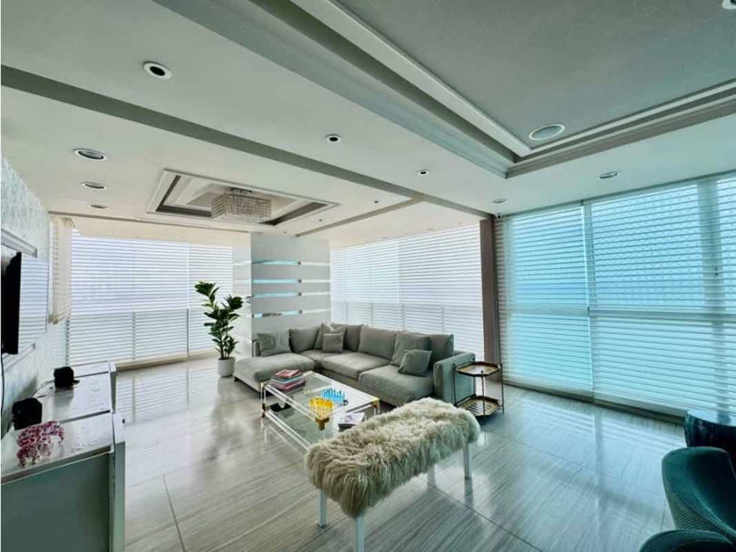 Spacious living room with large windows, sectional sofa, city views in Oceanaire Punta Pacifica