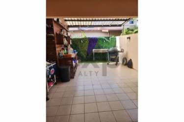 Patio with outdoor grill, artificial grass wall, tiled floor in duplex house Panama Pacifico