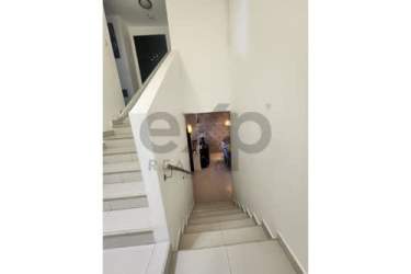 Bedroom with large sliding closet, bed with blue bedding, TV, ceiling fan in Woodlands Panama Pacifico