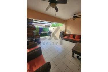 Covered terrace patio with wicker sofas, ceiling fans in Woodlands Panama Pacifico